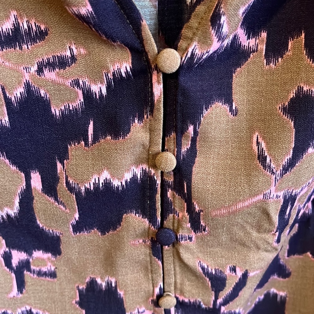 None west blouse. Button up. Thick fabric, but still flowy with the cut.